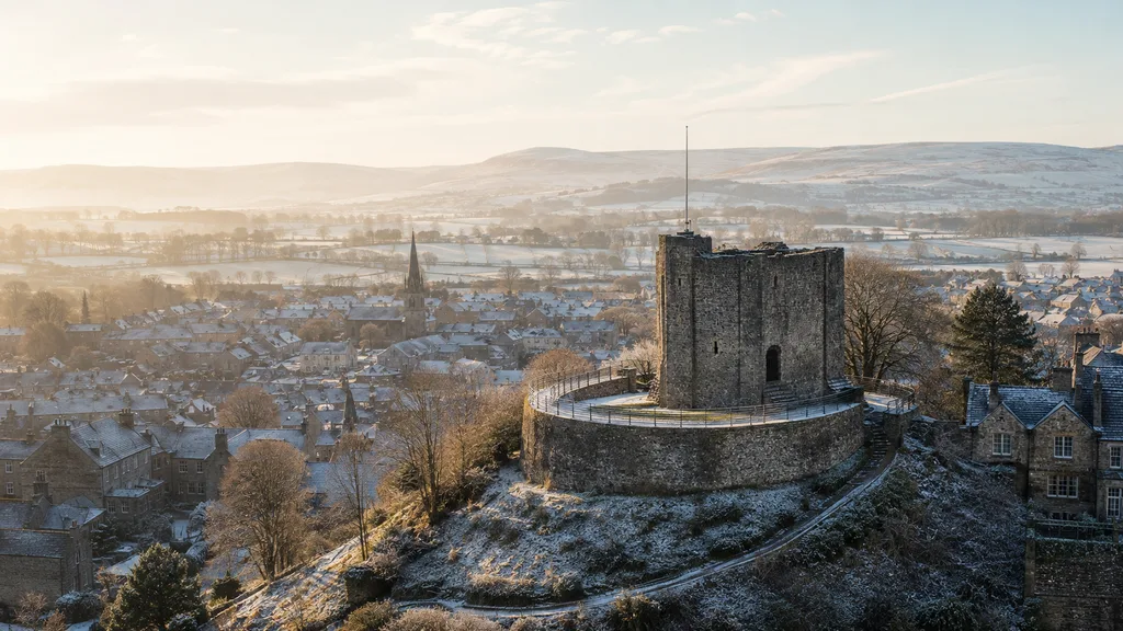 A winter view across Clitheroe and its castle towards the Ribble Valley hills